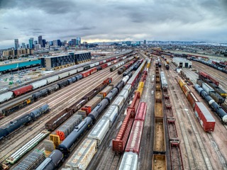 Rail yard with freight cars and city skyline